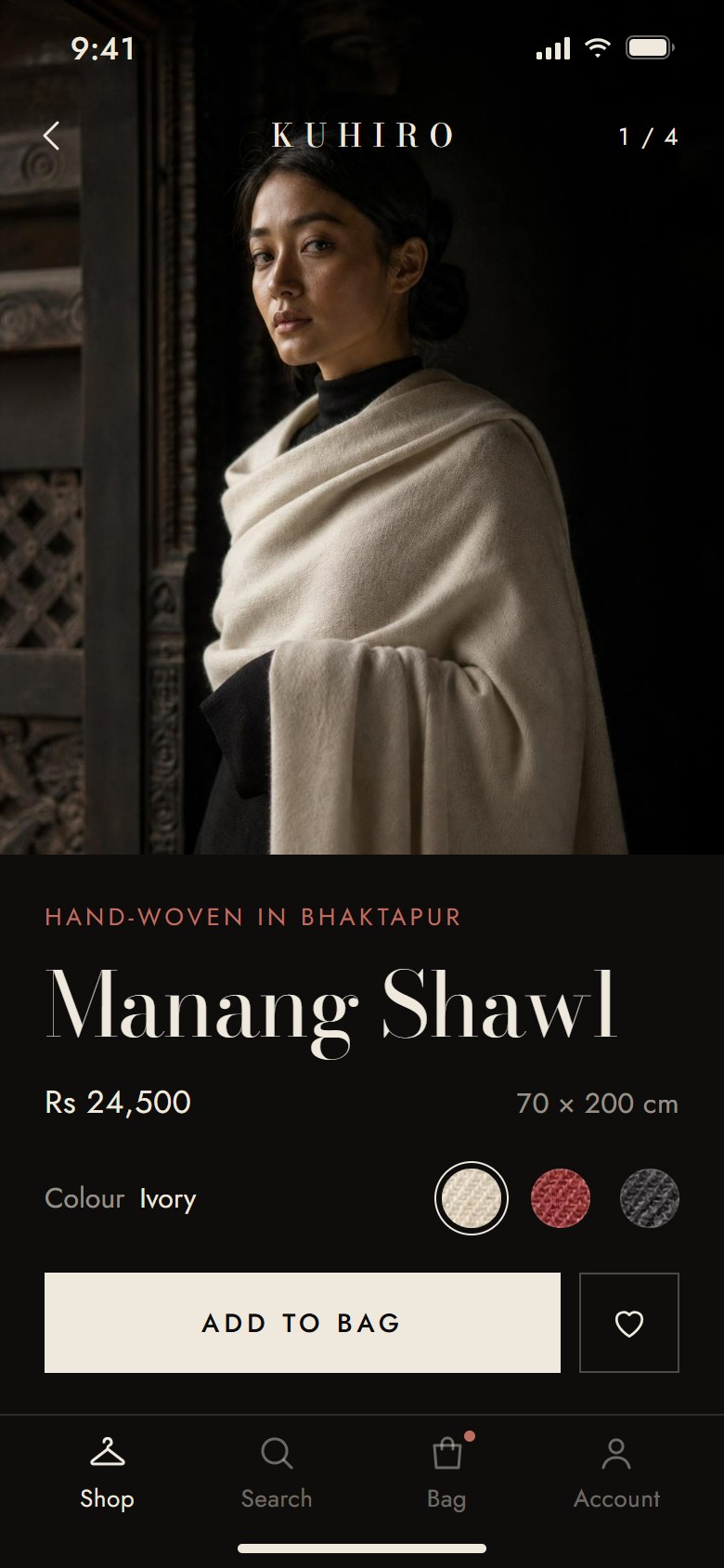 A pashmina label's app on a phone, in one of Doko's designs: a model in an ivory shawl in a dark Newari room, the Manang Shawl with its price and size, three woven colour swatches, and Add to bag.